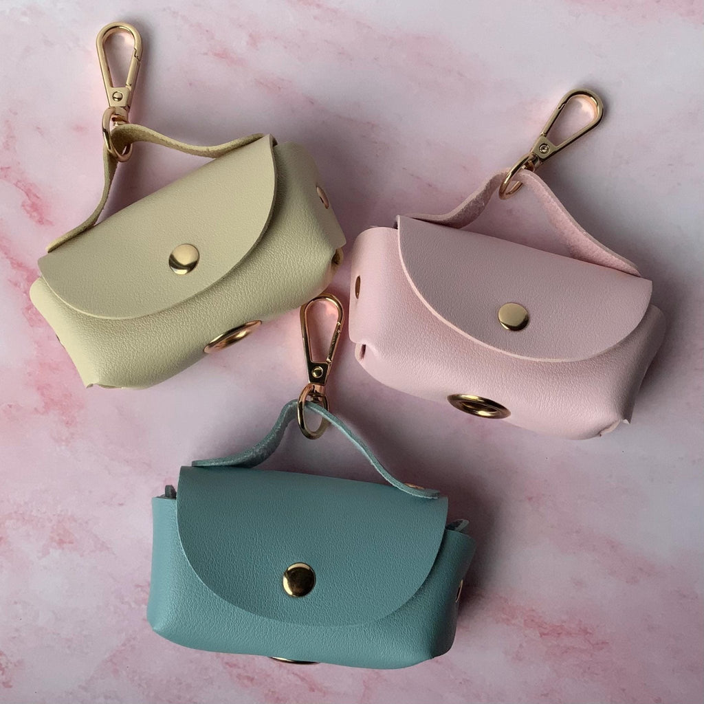 Pet Waste Bag Dispenser Elegant Faux Leather Design Portable Dog Supply Organizer Leash Attachment System Convenient Storage Solution Premium Quality Construction Durable Metal Clasp Stylish Pastel Colors Daily Walk Essential Beautiful Pet